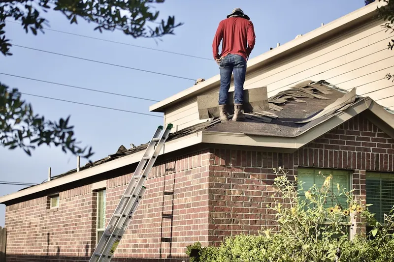 Professional roofer working on a residential roof in Oberlin